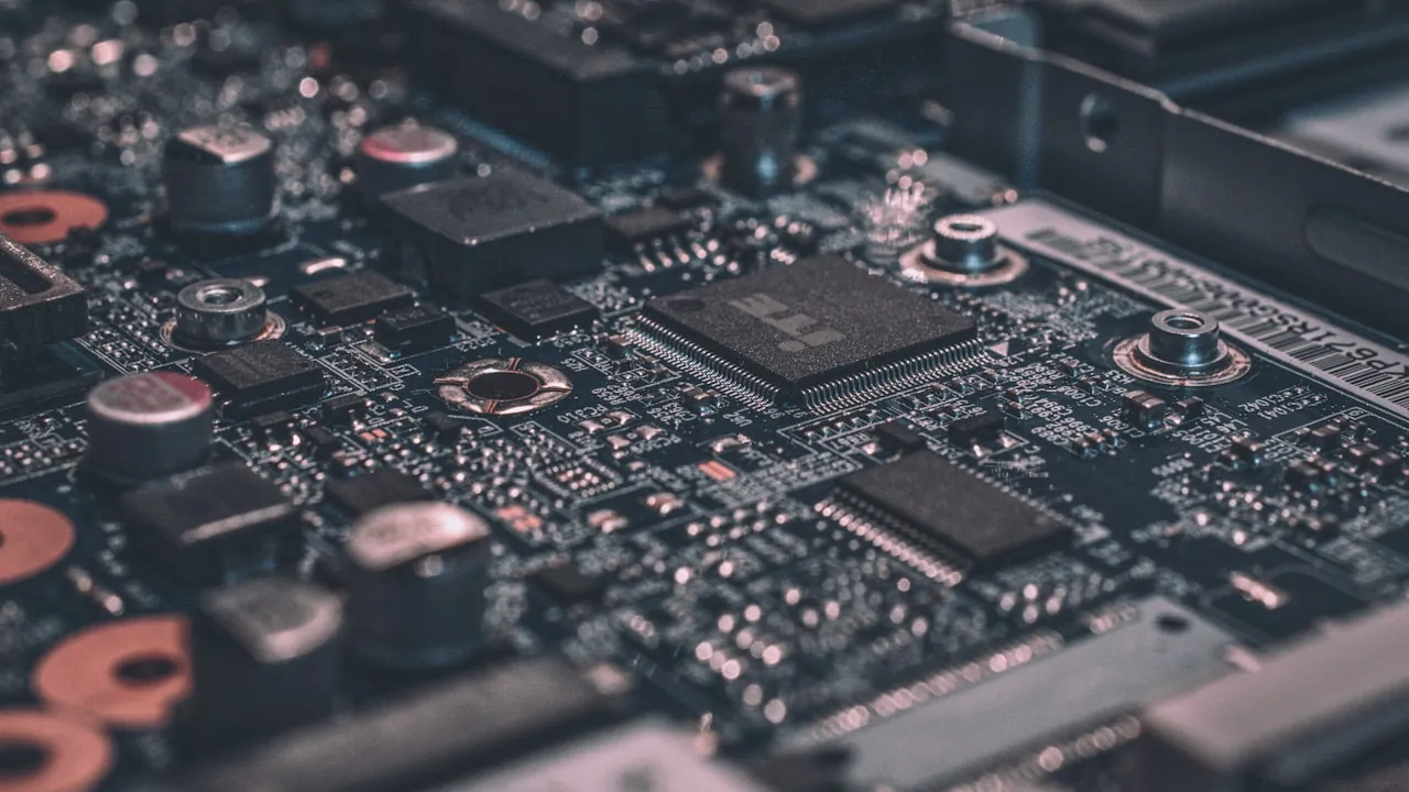 A circuit board lit in warm light — the automated filter that decides who stays on a moderated random video chat
